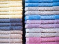 Stack of colorful terry towels folded. Shop Home. Numerous towels stacked and folded on the shelves of a store Royalty Free Stock Photo