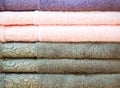 Stack of colorful terry towels folded. Shop Home. Numerous towels stacked and folded on the shelves of a store Royalty Free Stock Photo