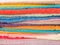 Stack of colorful terry towels folded. Shop Home. Numerous towels stacked and folded on the shelves of a store Royalty Free Stock Photo