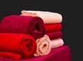 Stack of colorful terry towels on a table on dark background