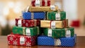 A stack of colorfully wrapped presents is positioned on a wooden surface Royalty Free Stock Photo