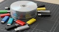 Stack of Compact Discs with Colorful Usb Flash Drives on Black Grid Surface Royalty Free Stock Photo