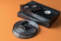 A stack of compact discs and video-audio tapes and a flash drive on an orange background Royalty Free Stock Photo