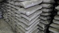 Stack of concrete bags in a godown area.