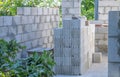 A stack of concrete cinder blocks is set up for construction in the backyard, with some greenery and trees visible Royalty Free Stock Photo