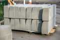 Stack of concrete road curbs in a yard for the overhaul of a sidewalk, organised by municipal public utility service. Royalty Free Stock Photo