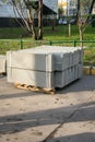 Stack of concrete road curbs in a yard for the overhaul of a sidewalk, organised by municipal public utility service. Royalty Free Stock Photo