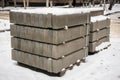 Stack of concrete road curbs in a yard for the overhaul of a sidewalk, organised by municipal public utility service. Royalty Free Stock Photo