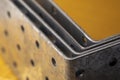 Stack of construction perforated steel angle brackets close up Royalty Free Stock Photo