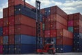 Stack of container box in transportation port with container lift car Royalty Free Stock Photo