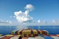 Stack of the containers loaded on deck of the cargo ship.