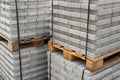 Stack of contemporary stone Paving slabs pavers. Building material on pallet for road paving. Royalty Free Stock Photo