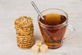 Stack of cookies with sesame seeds, sugar and tea Royalty Free Stock Photo