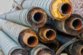 Stack of corroded steel pipes with worn insulation industrial background Royalty Free Stock Photo