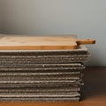 A stack of corrugated cardboard sheets, neatly arranged on a wooden table, serves a Royalty Free Stock Photo