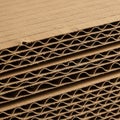 Stack of corrugated cardboard sheets showing a series of parallel layers. Each sheet consists of a Royalty Free Stock Photo