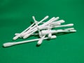 Stack cotton buds with soft cotton, on a green background. close up.