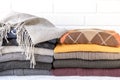 Stack of cozy knitted sweaters preparing warm clothes for autumn winter seasons concept. Royalty Free Stock Photo