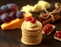 Stack of crackers with apple chutney and other snacks