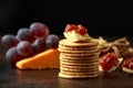 Stack of crackers with apple chutney and other snacks