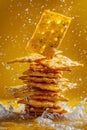 Stack of crackers falling into amber liquid, fast food cuisine