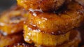 A stack of crispy fried plantains drizzled with a sweet coconut glaze and dusted with cinnamon