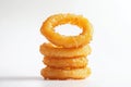 A stack of crispy, golden onion rings on a white background Royalty Free Stock Photo