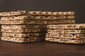 Stack of crispy wheat, rye and corn flatbread crackers. Healthy food background. High angle view