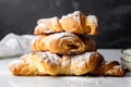 stack of croissants, layered with rich and flaky dough, and topped with a dusting of powdered sugar