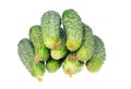 Stack of cucumbers with dry flowers isolated over white Royalty Free Stock Photo