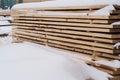 Stack of cut wood under the snow,woodpile stacked of firewood under the snow