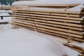 Stack of cut wood under the snow,woodpile stacked of firewood under the snow