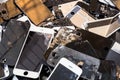 Stack of damaged smart phone body and cracked LCD screen