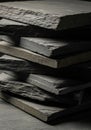 Stack of dark gray slate tiles, each with a rough, uneven surface and irregular edges. Royalty Free Stock Photo