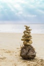 Stack of dead coral reef on the old coconut fruit over blurred beach, outdoor day light Royalty Free Stock Photo