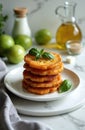 Stack of deep fried green tomato slices on white plate. Served with fresh basil leaves. Background features green tomatoes olive Royalty Free Stock Photo
