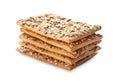 Stack of delicious crispy crackers with different seeds isolated on white