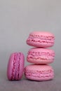 Stack of delicious french pink fruity flavour macarons on grey background