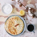 Stack of delicious homemade pancakes on plate with honey, sour cream and tea. Breakfast. Rustic style, close up top view. Flat lay Royalty Free Stock Photo