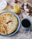 Stack of delicious homemade pancakes on plate with honey, sour cream and tea. Breakfast. Rustic style, close up top view. Flat lay Royalty Free Stock Photo