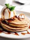 Delicious pancakes on plate with maple syrup and ice cream topping Royalty Free Stock Photo