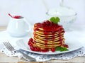 Stack of delicious pancakes with berries and jam on white background. Breakfast. View from side.