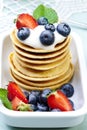 A stack of delicious pancakes with yogurt, blueberries and strawberries on a plate Royalty Free Stock Photo