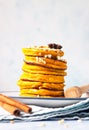 Stack of delicious pumpkin fluffy pancakes with maple syrup or honey and nuts. Healthy breakfast. Autumn food. Blue concrete Royalty Free Stock Photo