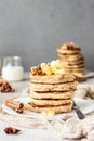 Stack of delicious sweet and spicy apple pancakes with fried caramelized apples and spices anise and cinnamon on a white plate Royalty Free Stock Photo