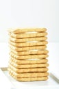 A stack of delicious wheat square biscuits with cream on white dish