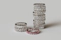 Stack of diamond eternity rings on white background