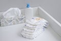 A stack of diapers and baby supplies on changing table Royalty Free Stock Photo