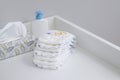A stack of diapers and baby supplies on white changing table Royalty Free Stock Photo