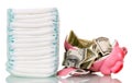 Stack diapers, broken piggy bank and money isolated on white.